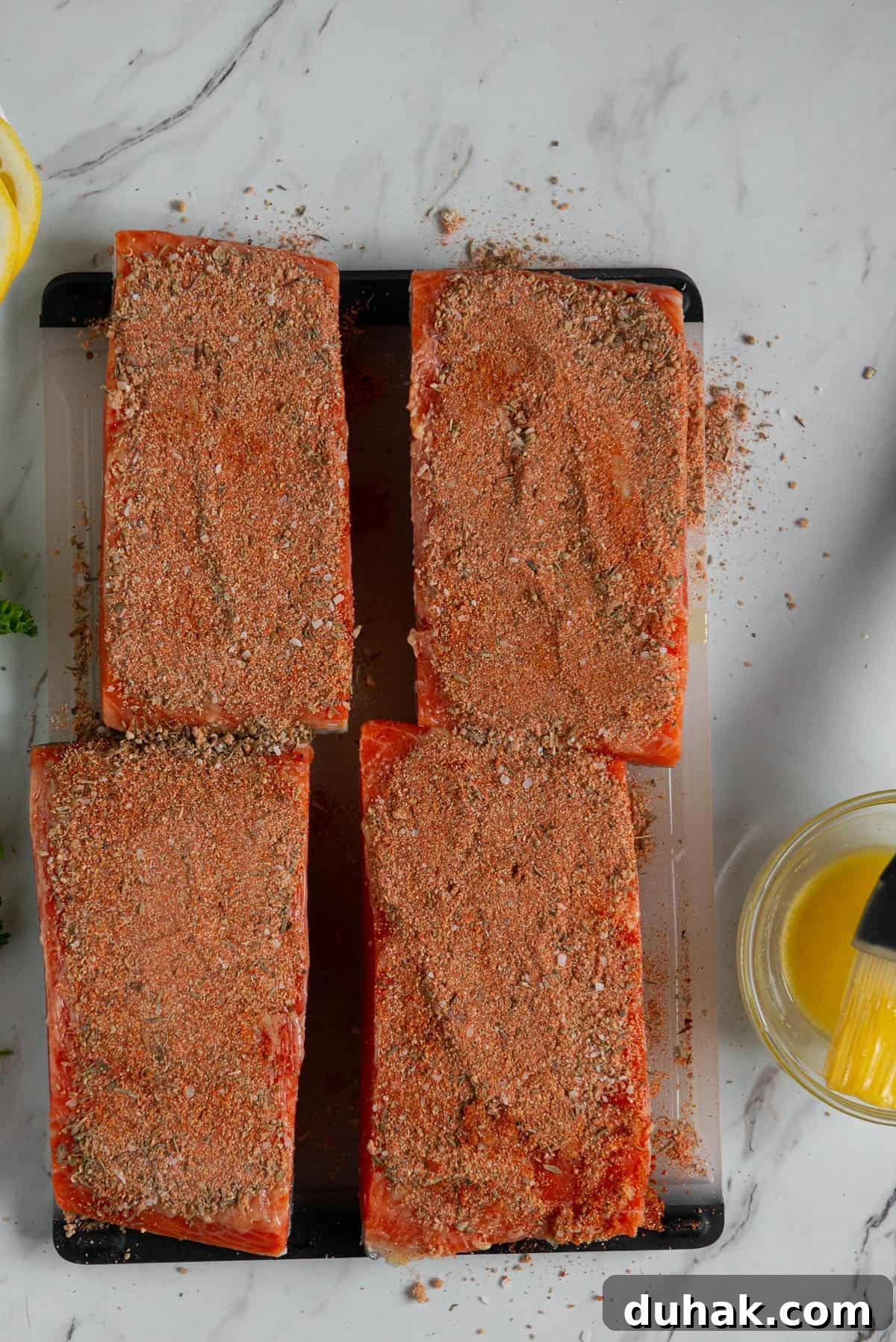 Blackened Salmon Recipe: Spicy Cajun Pan-Seared Fillets 8 Adding Cajun seasoning blend to butter brushed salmon filets.