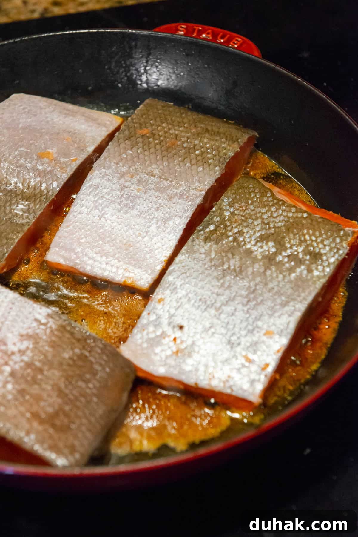 Blackened Salmon Recipe: Spicy Cajun Pan-Seared Fillets 9 searing Cajun seasoned salmon filets with skin side up.