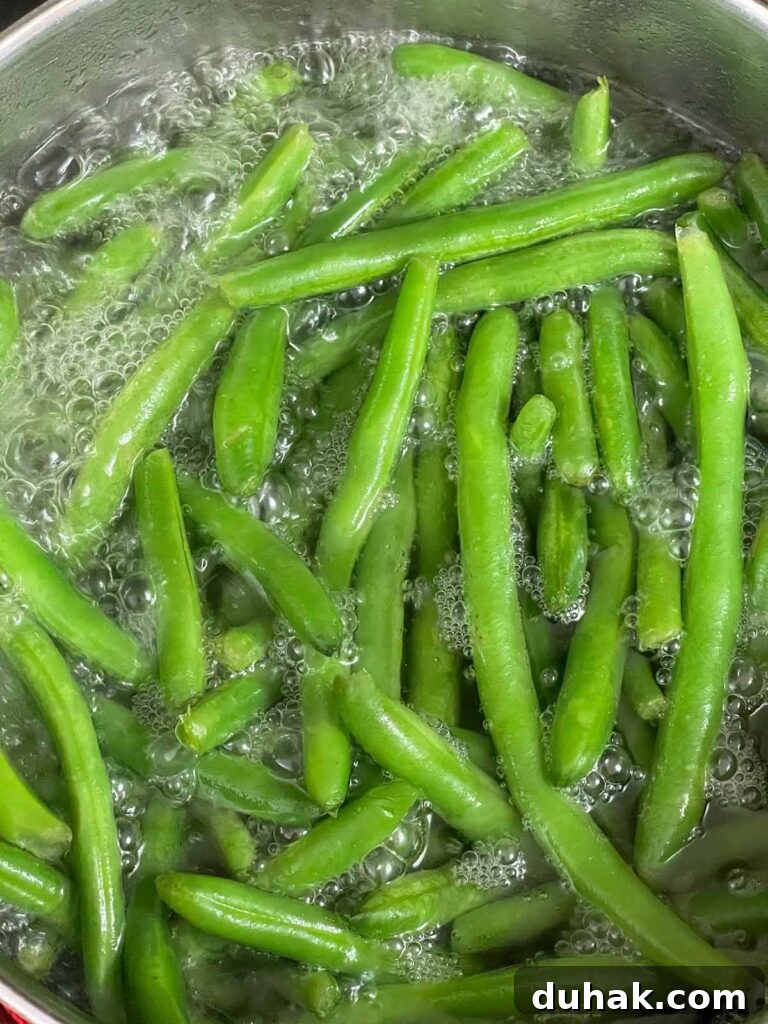 Green beans cooking until crisp tender in boiling water.