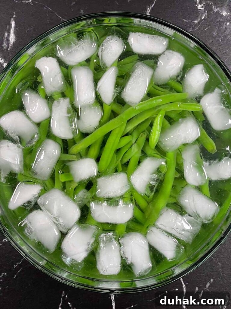 Green beans in ice bath to keep bright green color.