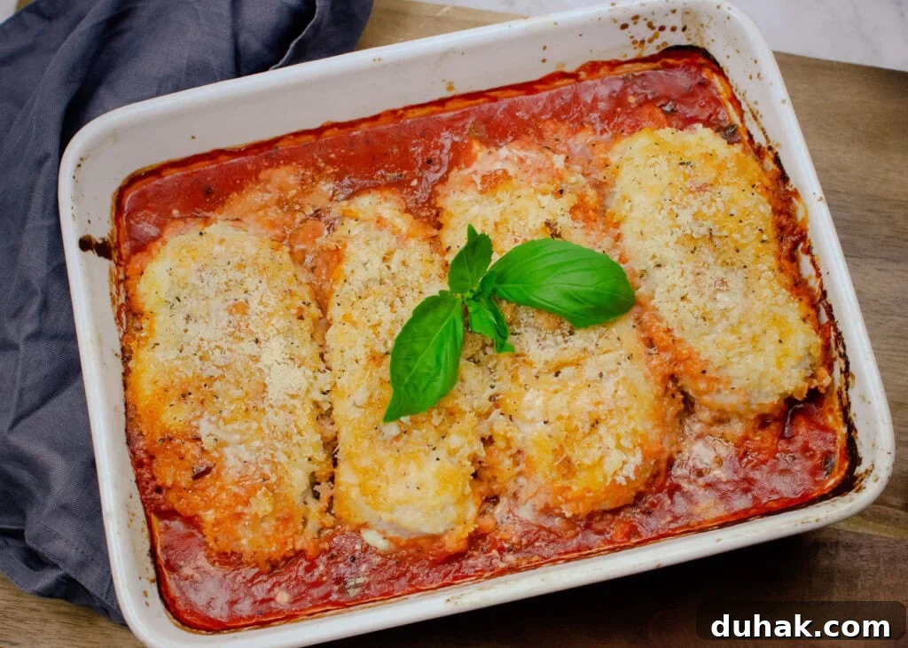 Parmesan chicken mozzarella in a tomato base sauce in a oven proof dish