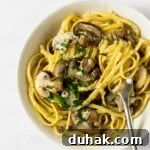 A close up view of a bowl of creamy mushroom pasta.