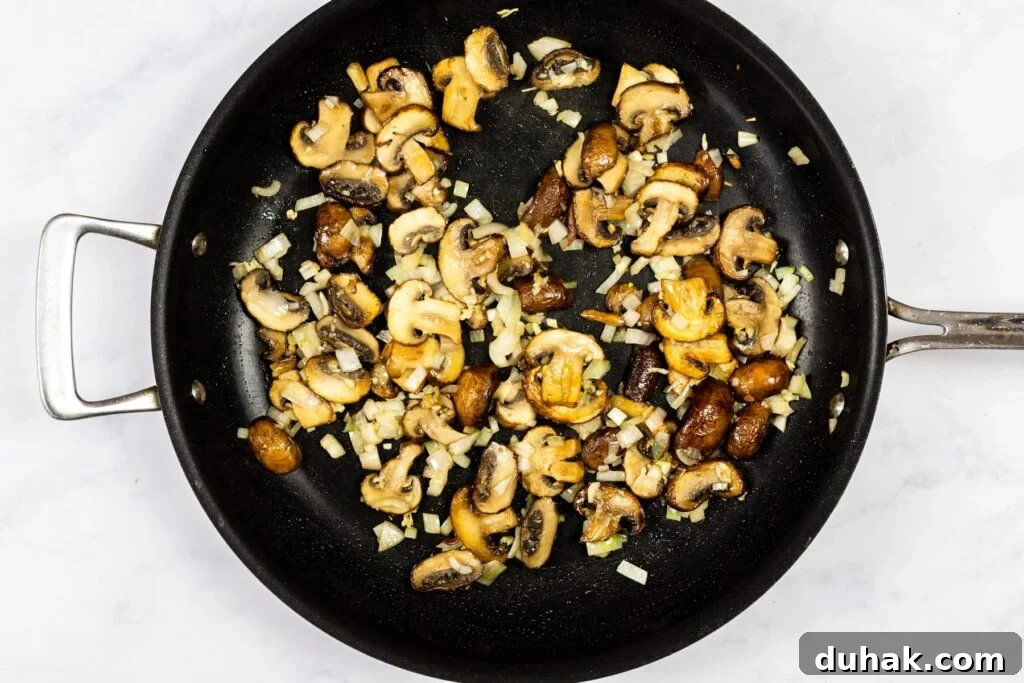 Mushrooms, shallots and garlic cooking in a skillet.