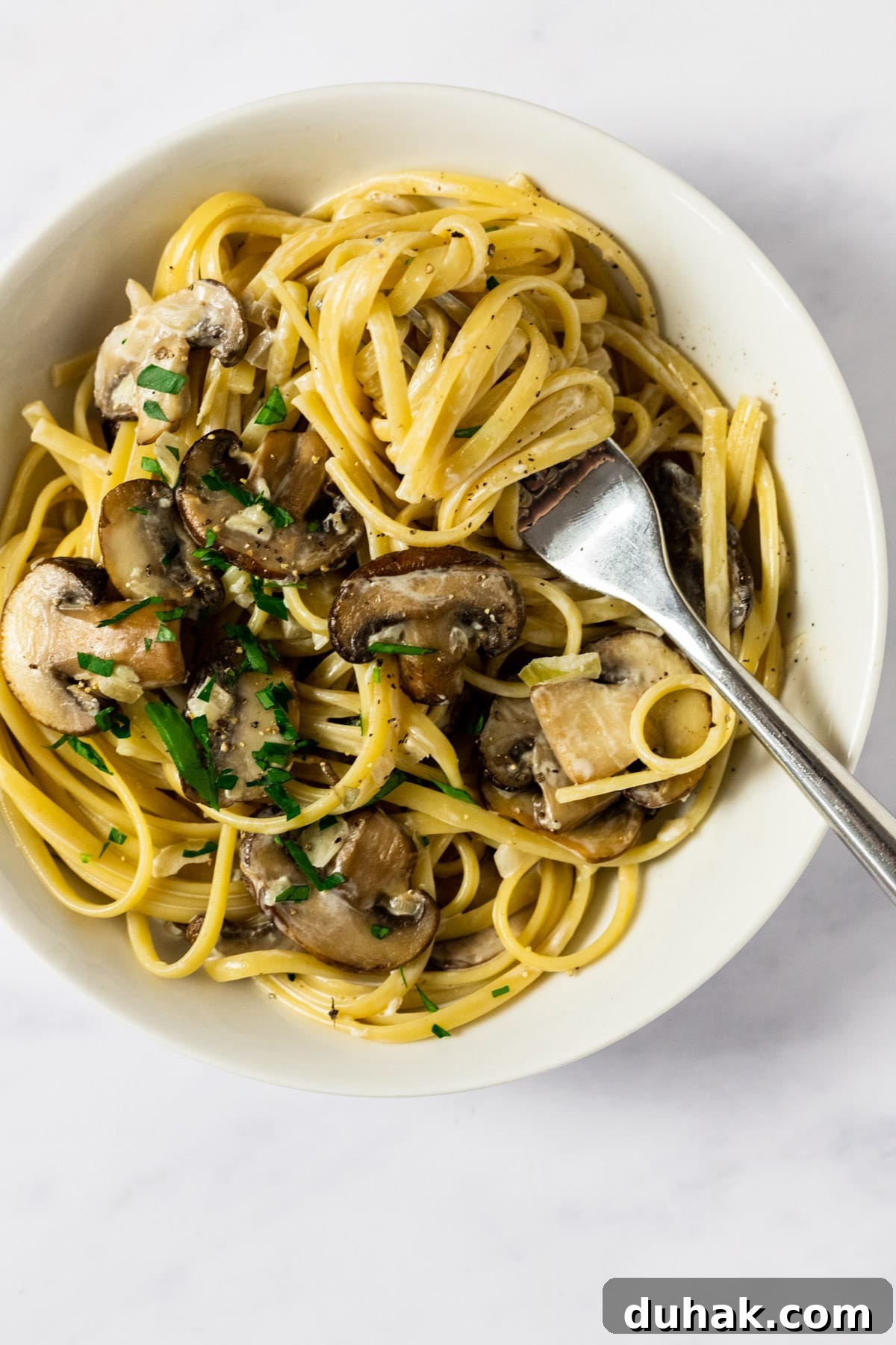 Easy, creamy, garlic mushroom pasta!  Enjoy this perfect vegetarian pasta with mushrooms in a garlic cream sauce in only 20 minutes time!