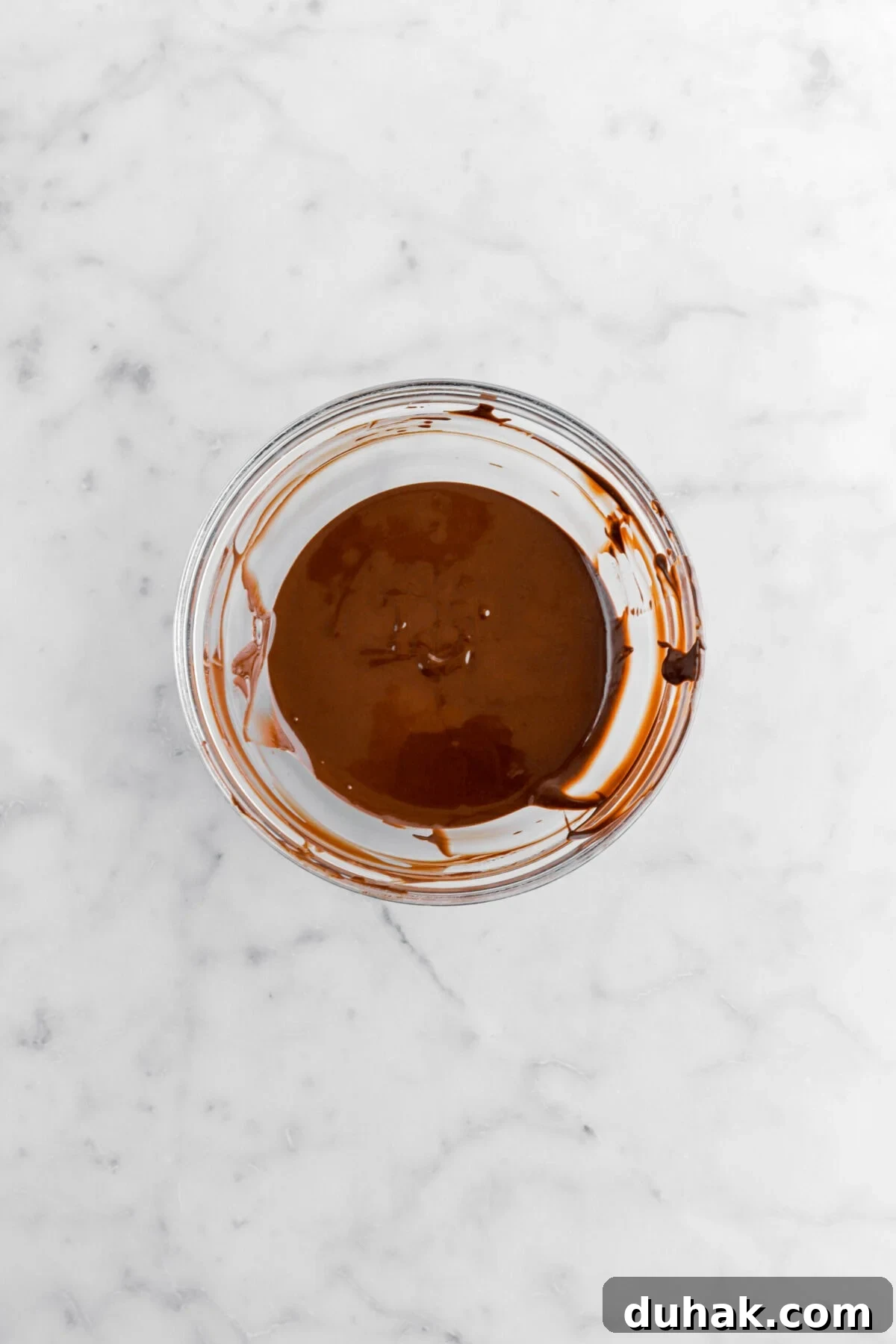 No-Bake Chocolate Peanut Butter Bars Recipe That Actually Sticks 4 melted chocolate in glass bowl.