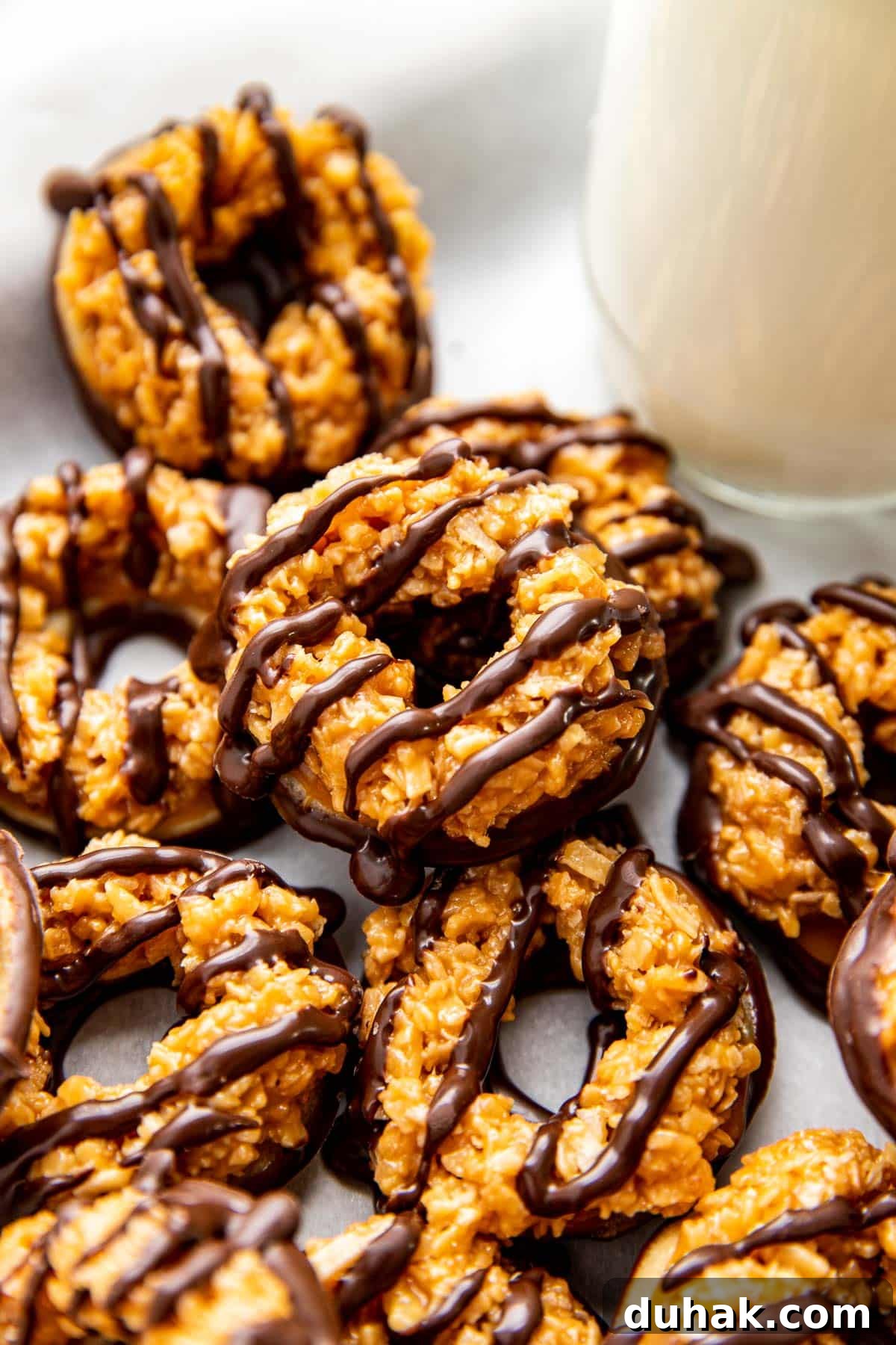 How to Make Samoas Cookies at Home — Girl Scout Copycat Recipe 9 homemade samoas on parchment paper.