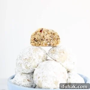 Mexican Wedding Cookies Recipe — Classic Crescent Cookies Guide 5 Grandma's Pecan Puffs stacked in blue bowl.