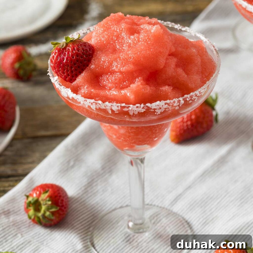 Refreshing Summer Cocktails, Mocktails & Fruity Drink Recipes 2 Frozen strawberry margarita served in a salt-rimmed glass with fresh strawberry garnish