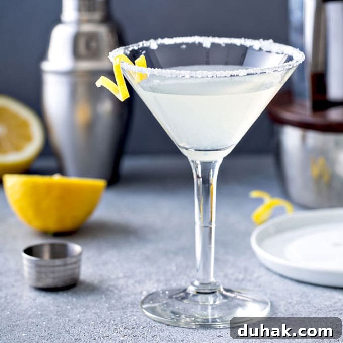 Refreshing Summer Cocktails, Mocktails & Fruity Drink Recipes 8 A glass of lemon drop martini cocktail with sugar on the martini glass and a lemon twist