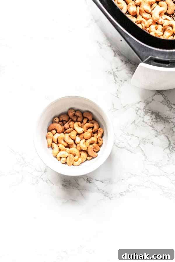 Tasty Air Fryer cashews served in a white bowl as a snack.