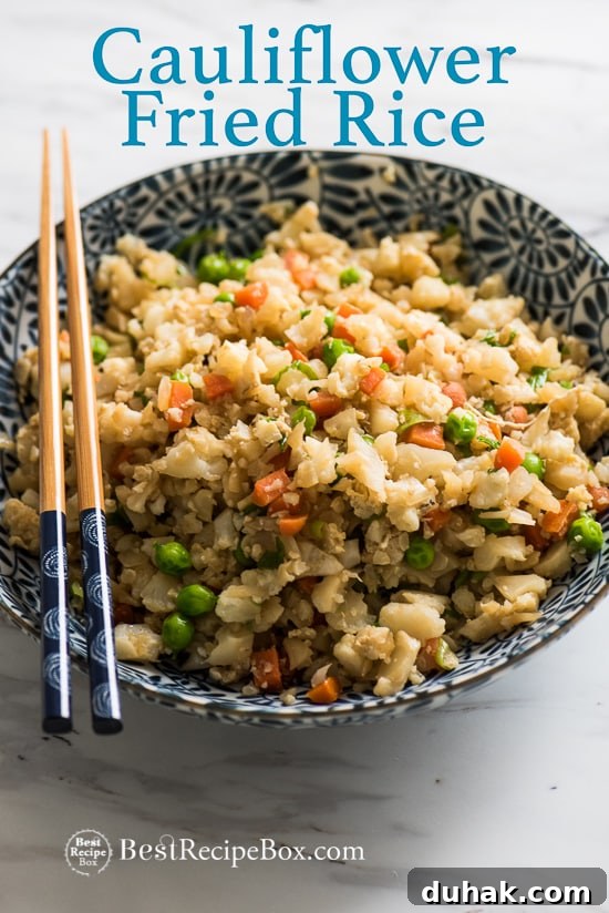 Cauliflower Fried Rice Recipe in a bowl with chopsticks 