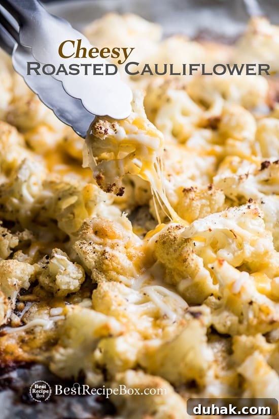Cheesy Roasted Vegetable Low Carb and Delicious on a cooking sheet pan with tong 