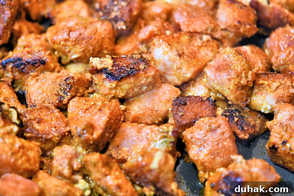 Authentic Pork Chile Colorado Asado Recipe — Savory Mexican Pork Stew 15 Delicious seared pork bites in a skillet.