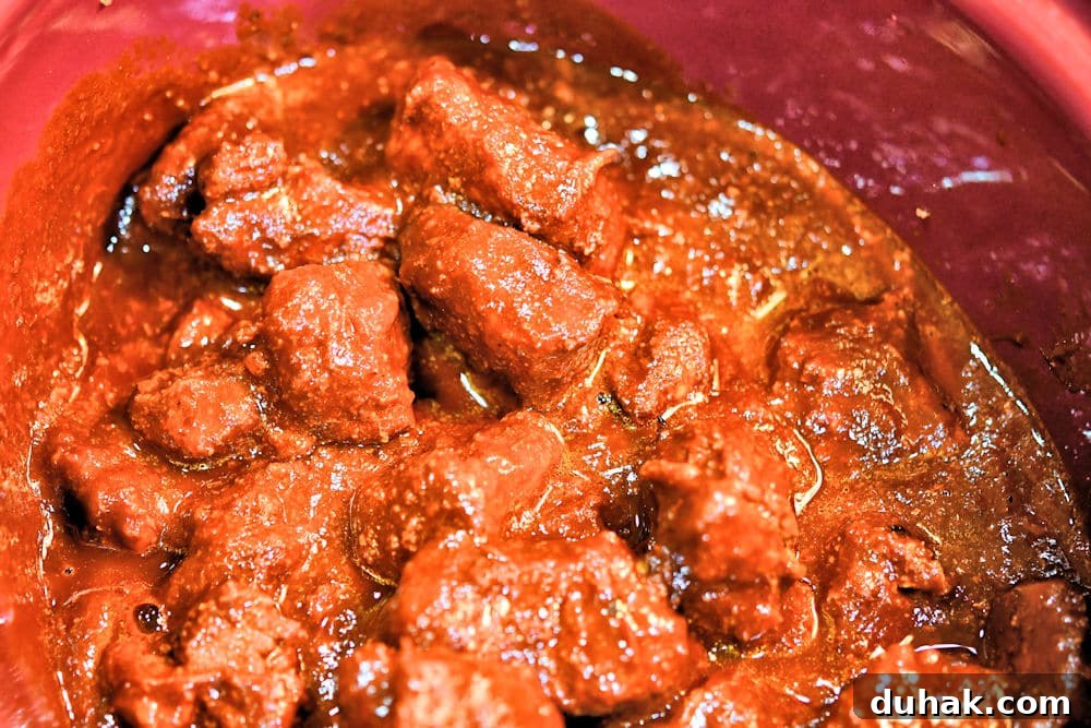 Authentic Pork Chile Colorado Asado Recipe — Savory Mexican Pork Stew 16 Mix the red chile sauce with the pork bites before slow cooking.