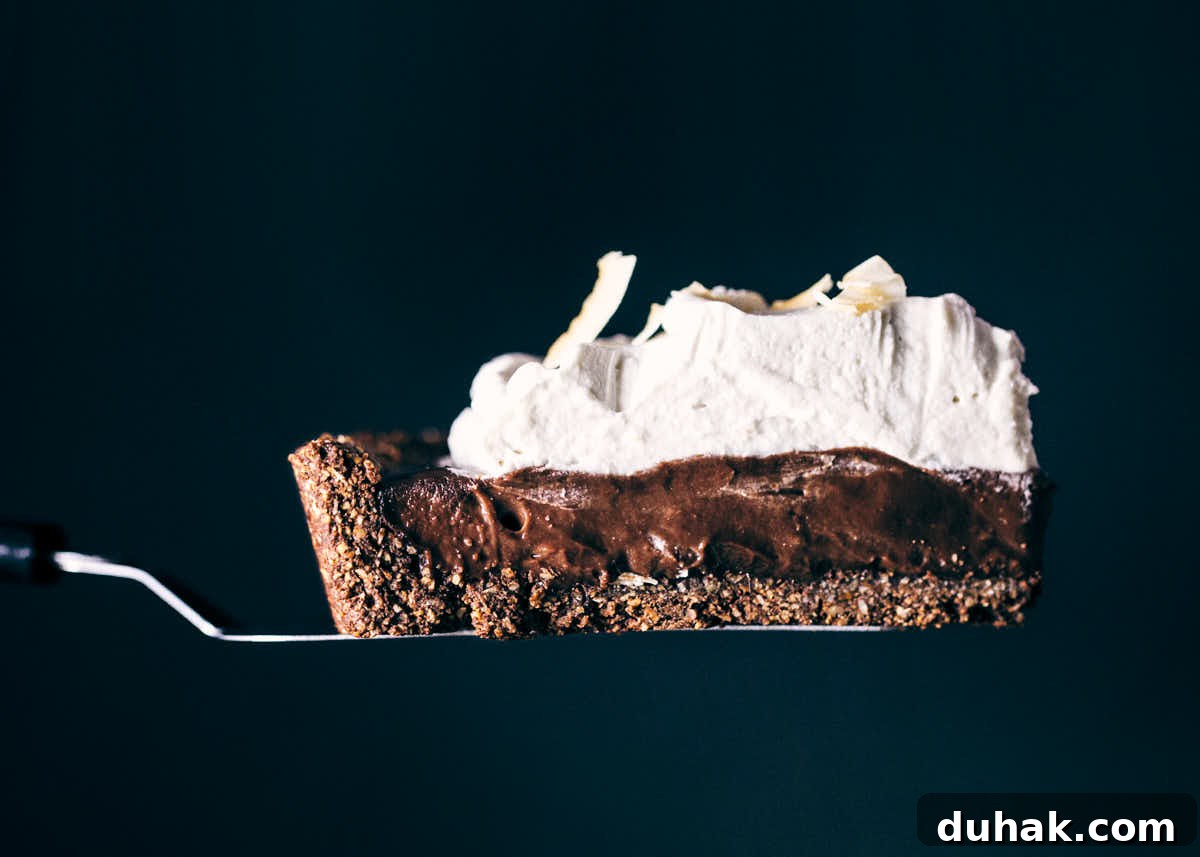 Slice of chocolate coconut cream pie being served