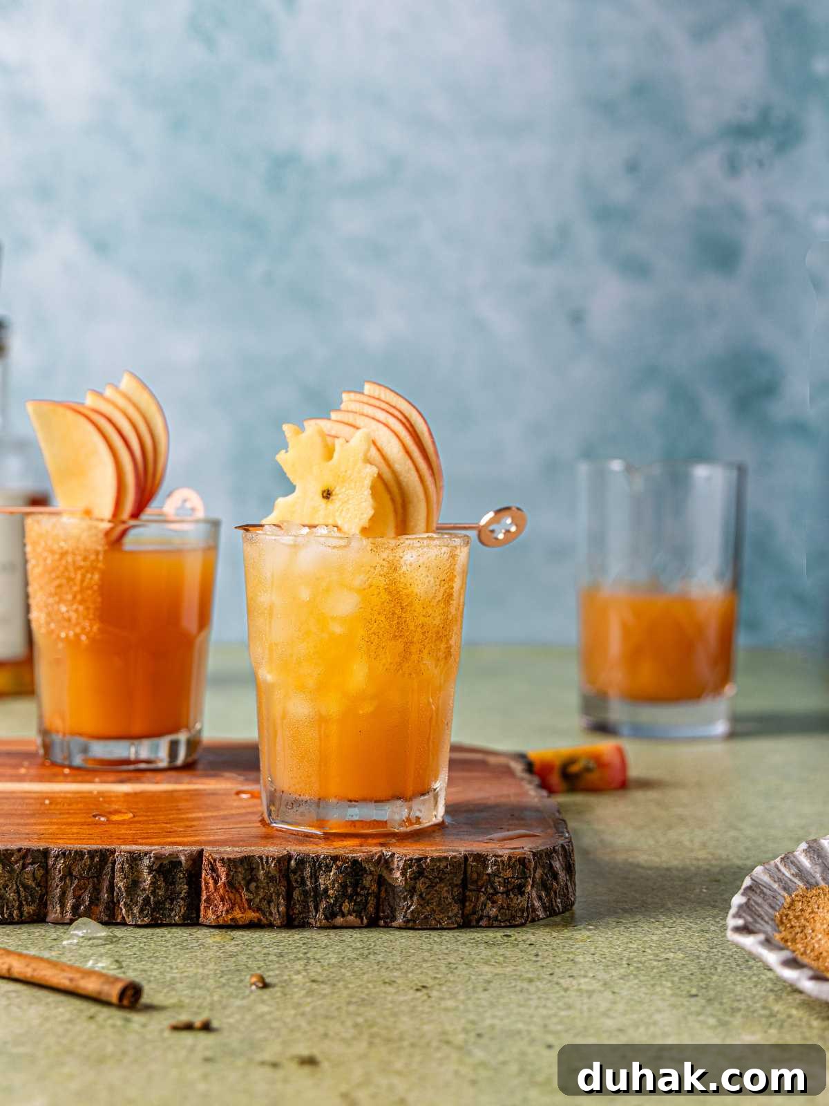 Bourbon and ginger ale in a glass with ice on top a serving block.