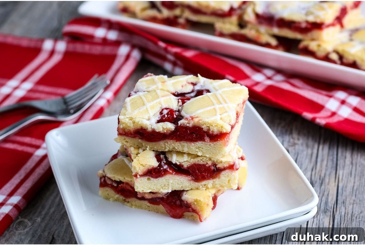 Glazed Cherry Bars: Simple Sweet Dessert Bars Recipe 6 White plate with three Cherry Pie Bars on a wood background | A Reinvented Mom