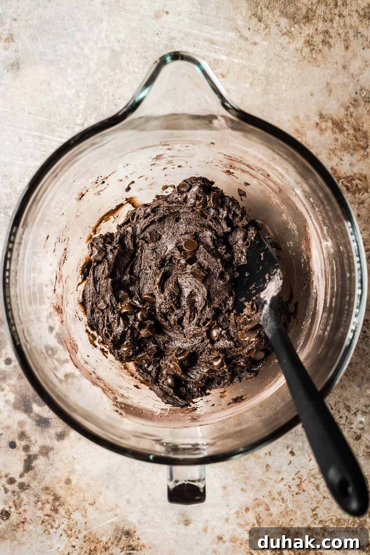 Double Cocoa Chocolate Cookies: Rich, Soft Baked Treats 11 A mixing bowl of chocolate cookie dough with chocolate chips and chunks added.