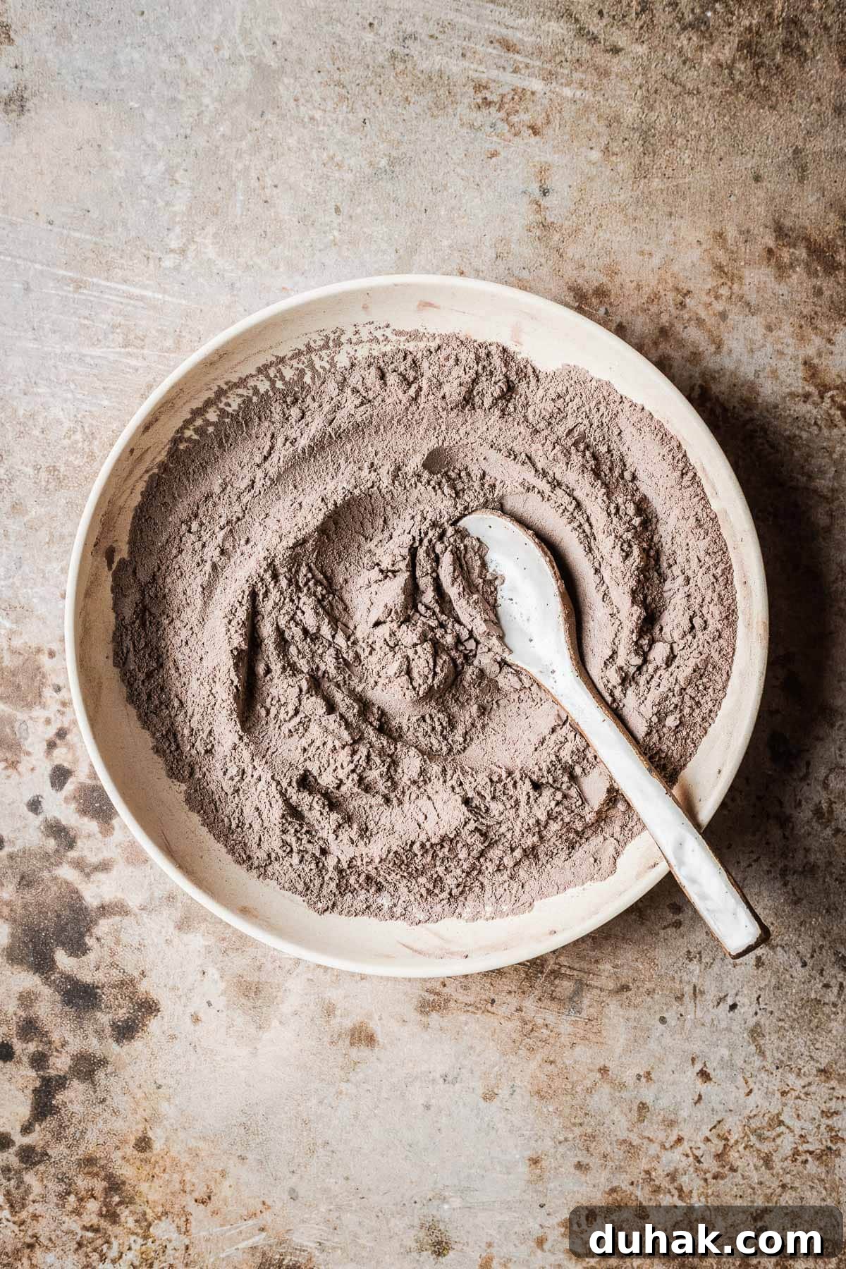 Double Cocoa Chocolate Cookies: Rich, Soft Baked Treats 5 Sifted dry ingredients for chocolate cookies with cocoa powder in a bowl.