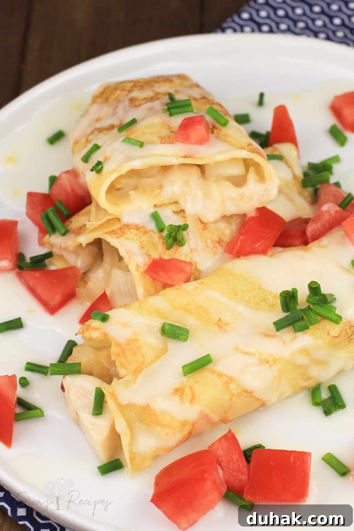 Savory Chicken and Potato Crepes: Rustic Filling Recipe 2 crepes with chicken and potato on white plate, one cut open to show filling
