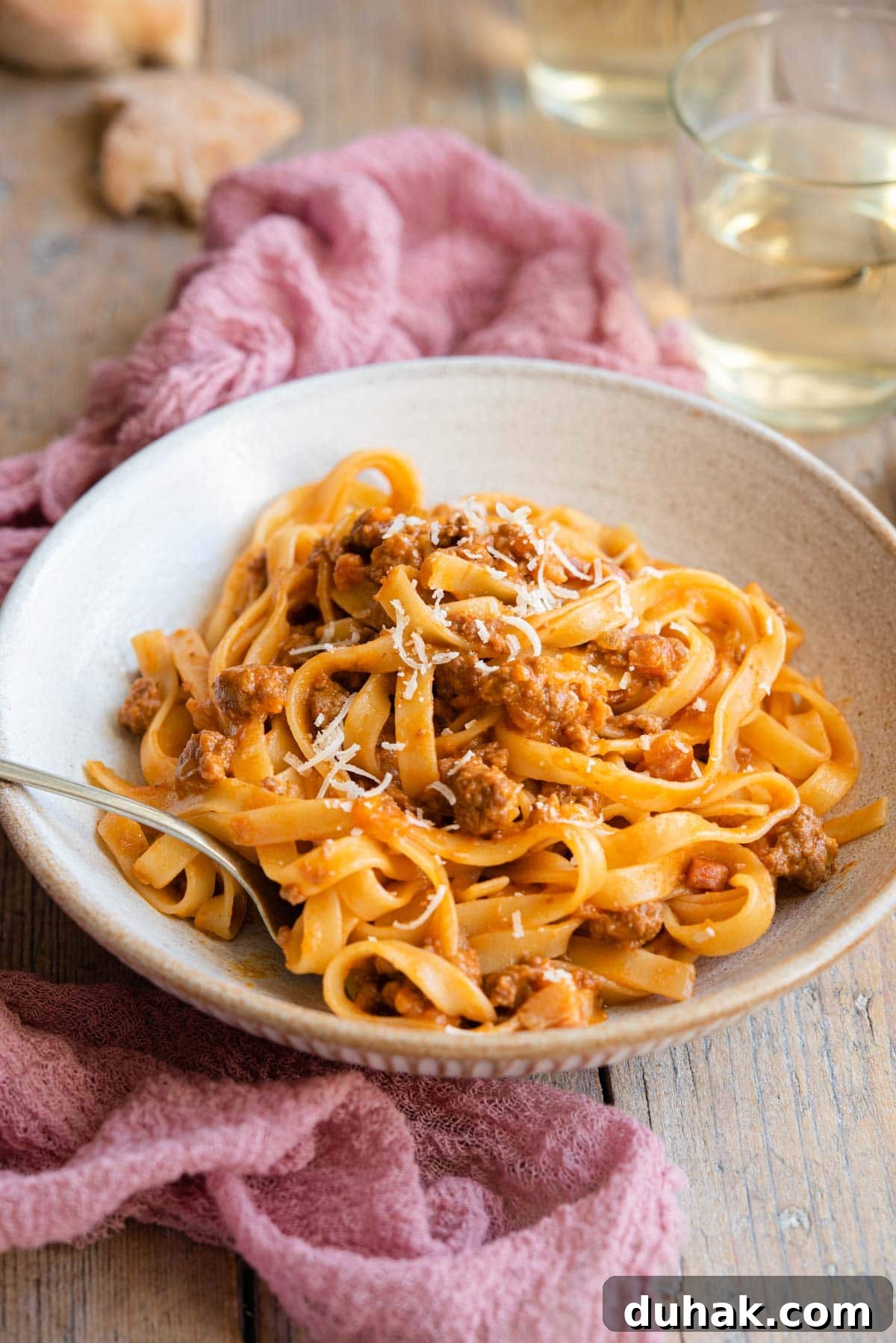 Authentic Ragù alla Bolognese: Classic Italian Meat Sauce Recipe 7 A side shot of bolognese sauce and tagliatelle in a rustic bowl
