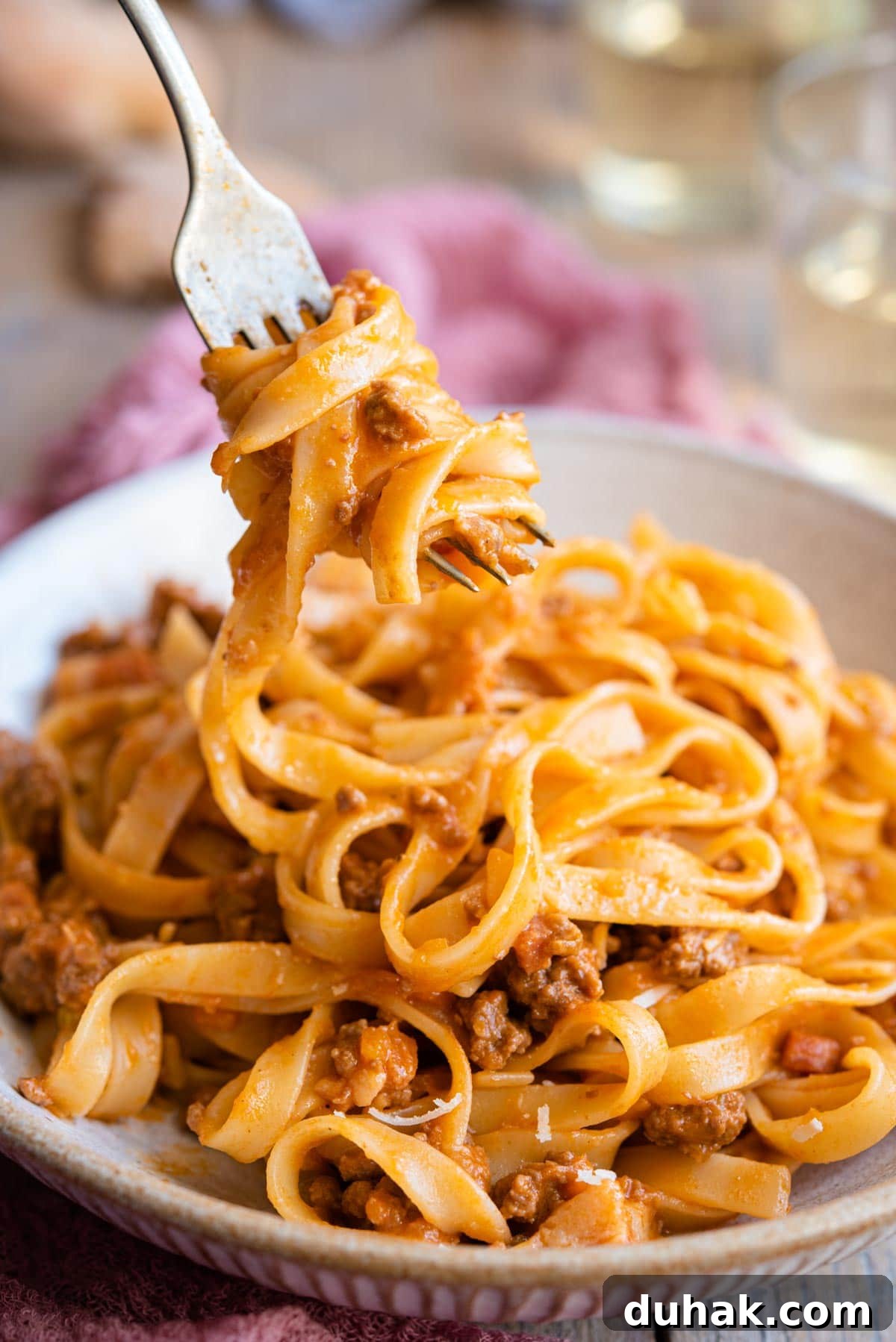 Authentic Ragù alla Bolognese: Classic Italian Meat Sauce Recipe 8 A close up of tagliatelli and bolognese sauce on a fork