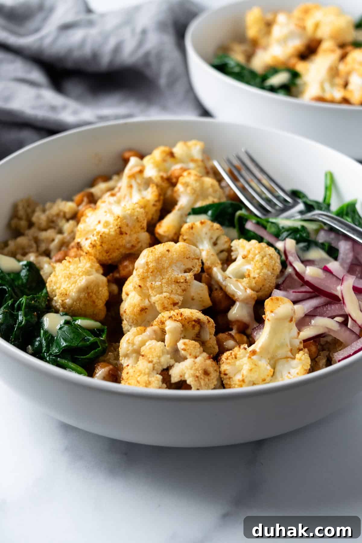 Roasted Cauliflower Bowls on a marble countertop.