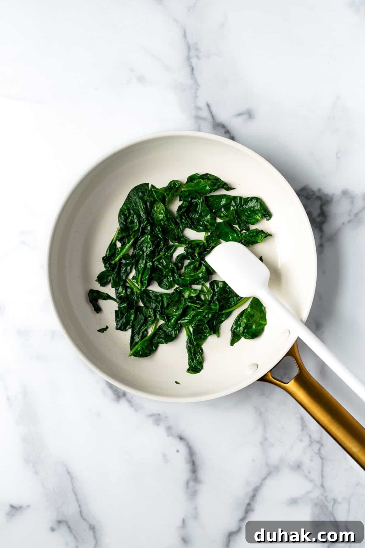 Sautéed Spinach in a White Skillet.