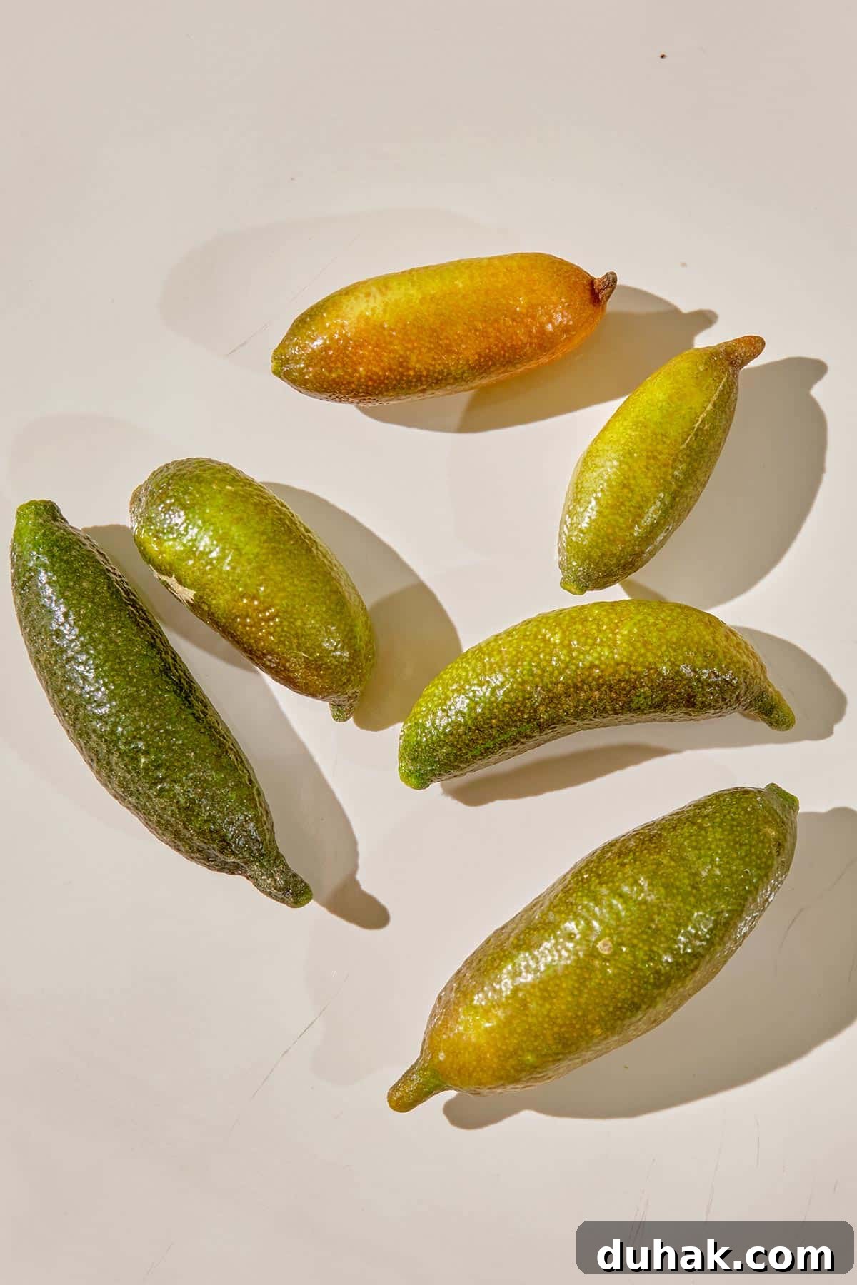 Fresh finger limes on white plate.