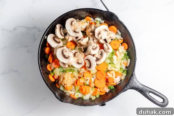 Comforting Gluten-Free Chicken with Fluffy Dumplings 6 vegetables sauteing in a skillet