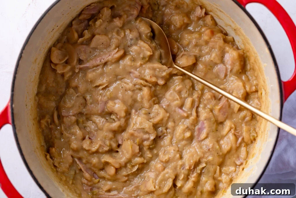 Southern-Style Creamy Butter Beans Recipe for Comfort Food 2 creamy butterbeans in a dutch oven with a gold spoon