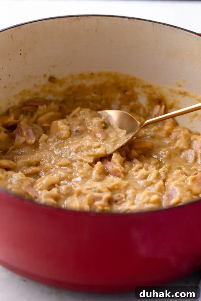 Southern-Style Creamy Butter Beans Recipe for Comfort Food 5 creamy butter beans in a dutch oven with a gold spoon