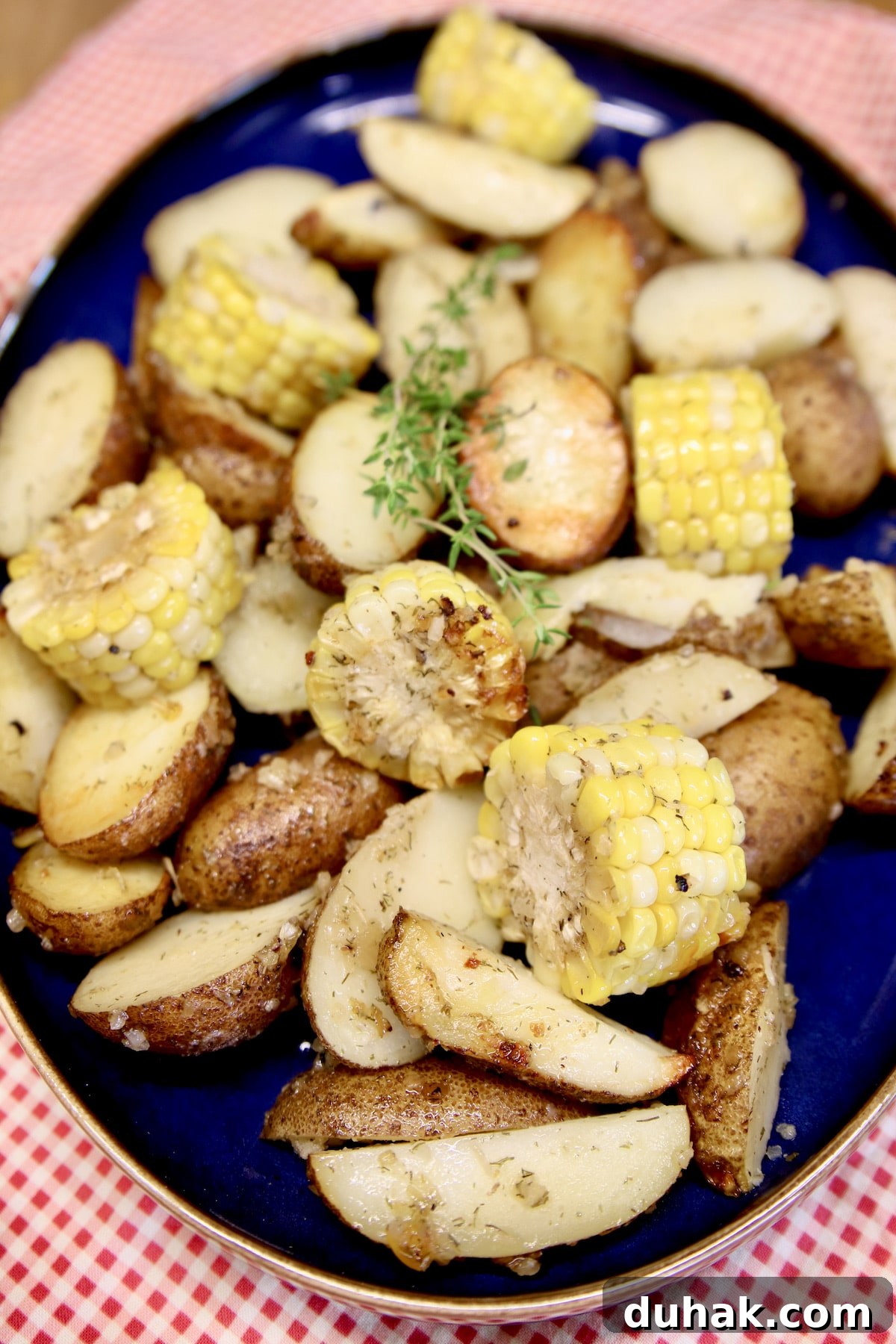 Platter with potatoes and corn cob slices.