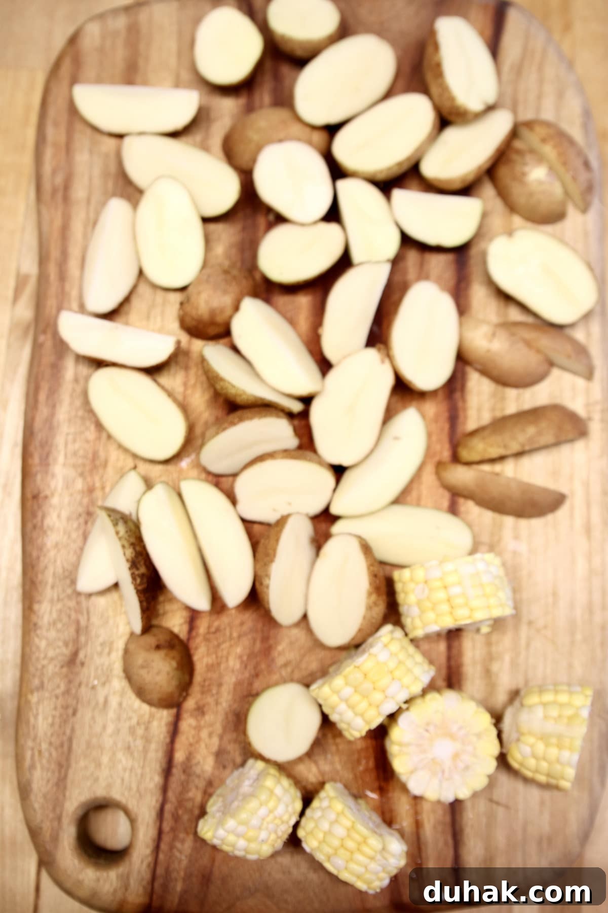 Baby potatoes sliced, corn on the cob, sliced.